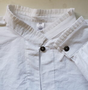 white cotton shirt with pleated collar, cuff and button closure