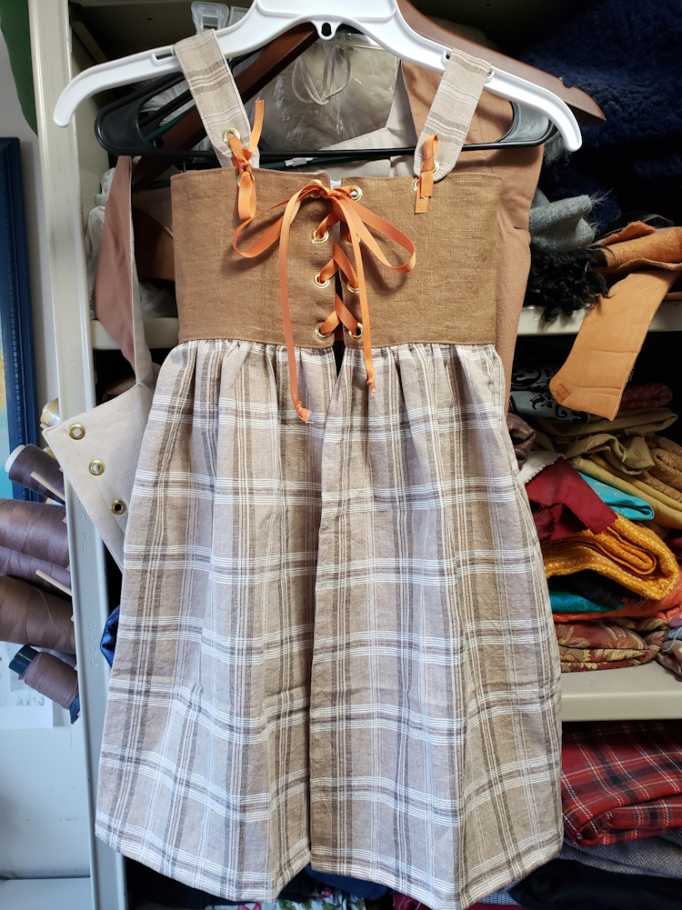 a child's renfaire dress on a hanger