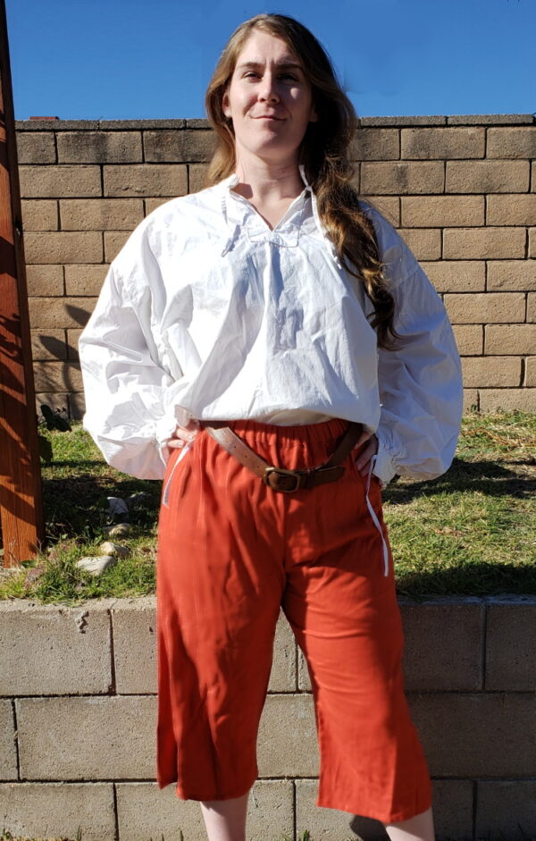 model wears rusty orange pirate breeches