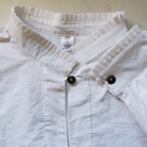 white cotton shirt with pleated collar, cuff and button closure